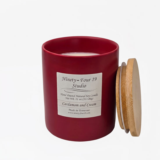 scented natural soy wax candle in a ruby ceramic container